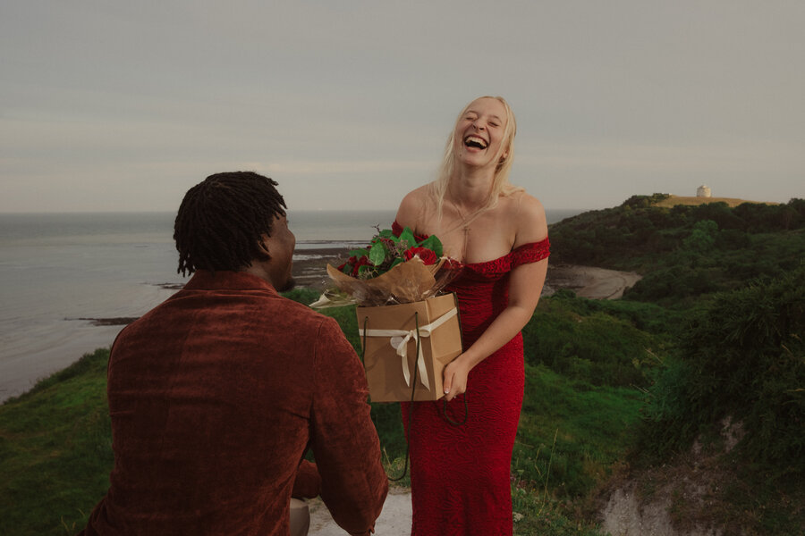 Saff laughing, holding the flowers Bam gave her